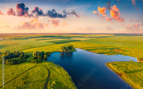Beautiful summer scenery. Splendid summer sunrise on Stara Brykulia lake, Ternopil region. Breathtaking rural scene from flying drone of Ukrainian countryside. Traveling concept background.