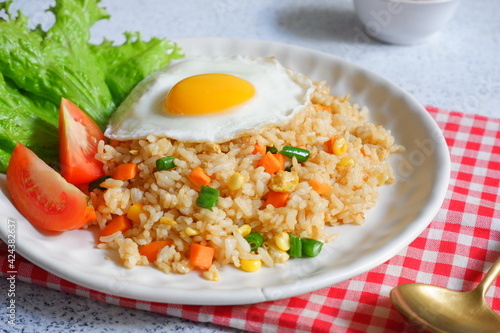 a plate of fried rice with vegetables and egg 