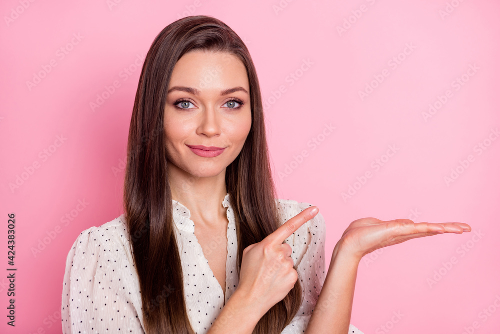 Photo of pretty person direct finger arm palm hold demonstrate empty space isolated on pink color background Photo of pretty person direct finger arm palm hold demonstrate empty space isolated on pink color background