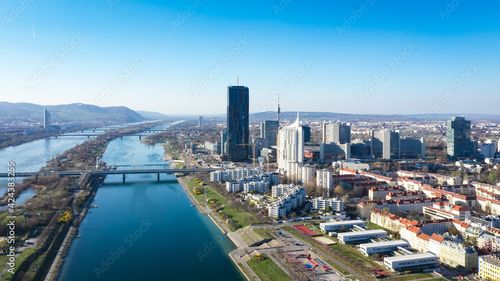 Vienna Danube and City aerial panoramic view. Donaustadt Kagran district at the Danube. Modern city quarter with skyscrapers and business office centres.