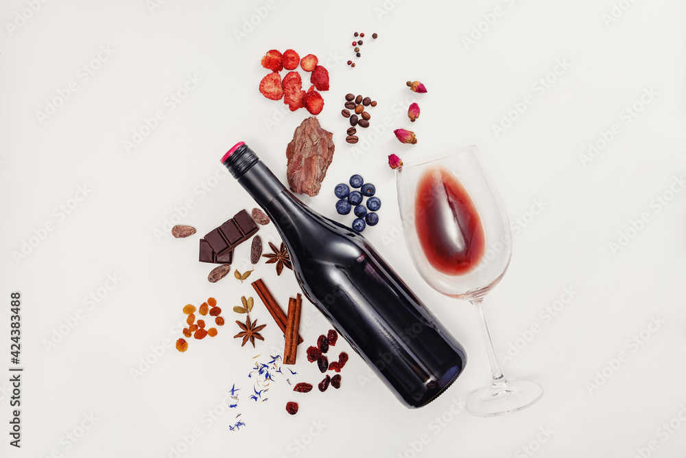 Composition with wine bottle, glass and possible flavor components of red wine - obrazy, fototapety, plakaty 