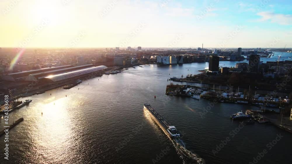 Amsterdam center, the Ij river at the central train station ships passing by Amsterdam center, the Ij river at the central train station ships passing by