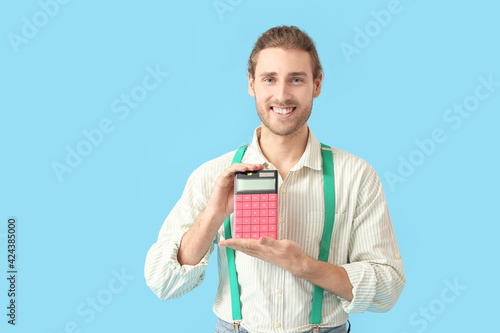 Young man with calculator o...