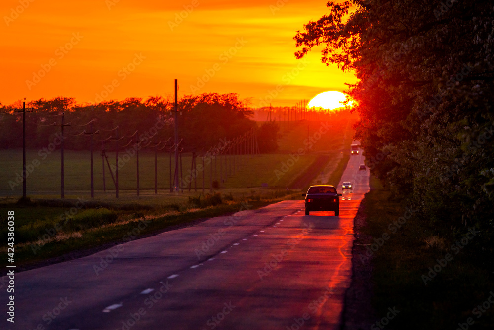 Beautiful sunset. Sundown on horizon. Traffic on a road Beautiful sunset. Sundown on horizon. Traffic on a road