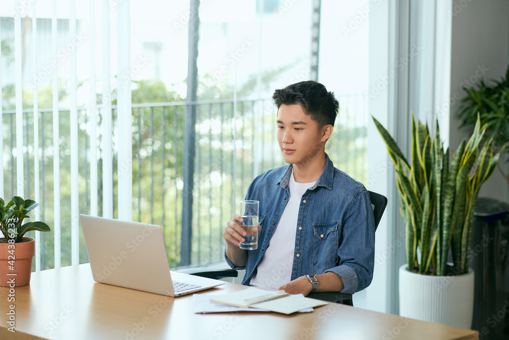 Freelance concept. Young bearded man working on laptop computer while sitting on terrace. Freelance concept. Young bearded man working on laptop computer while sitting on terrace.