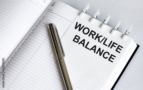 text WORK LIFE BALANCE on the short note texture background with pen