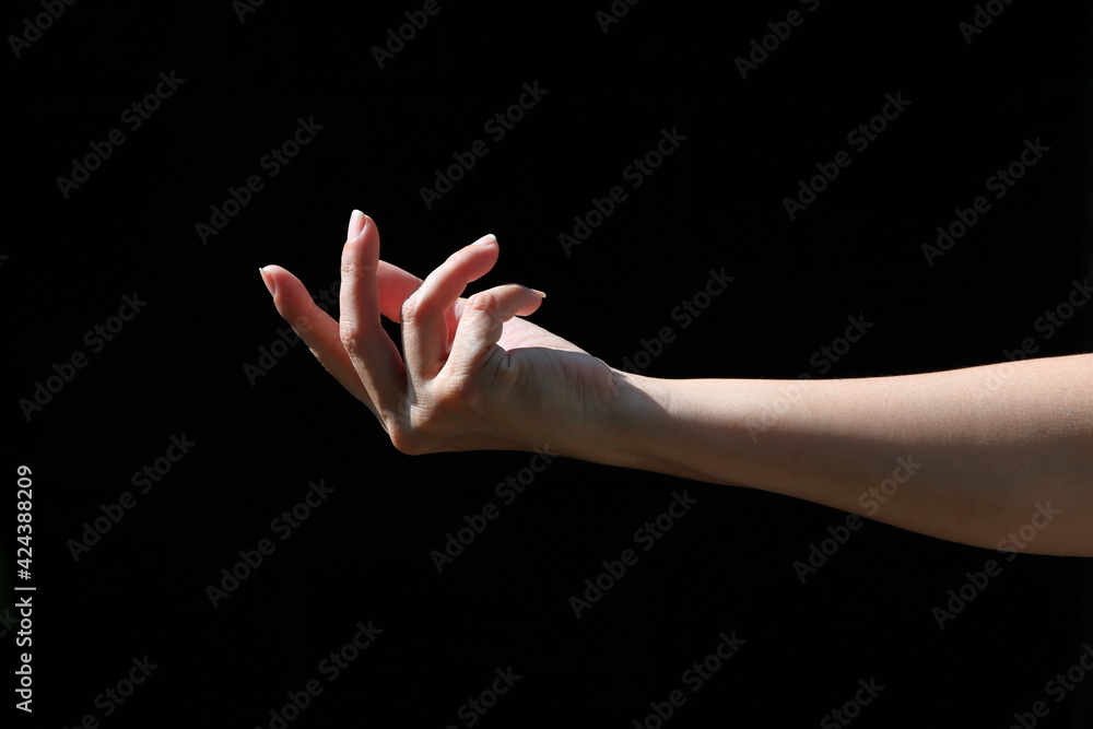 The girl's hands show various gestures on black background The girl's hands show various gestures on black background