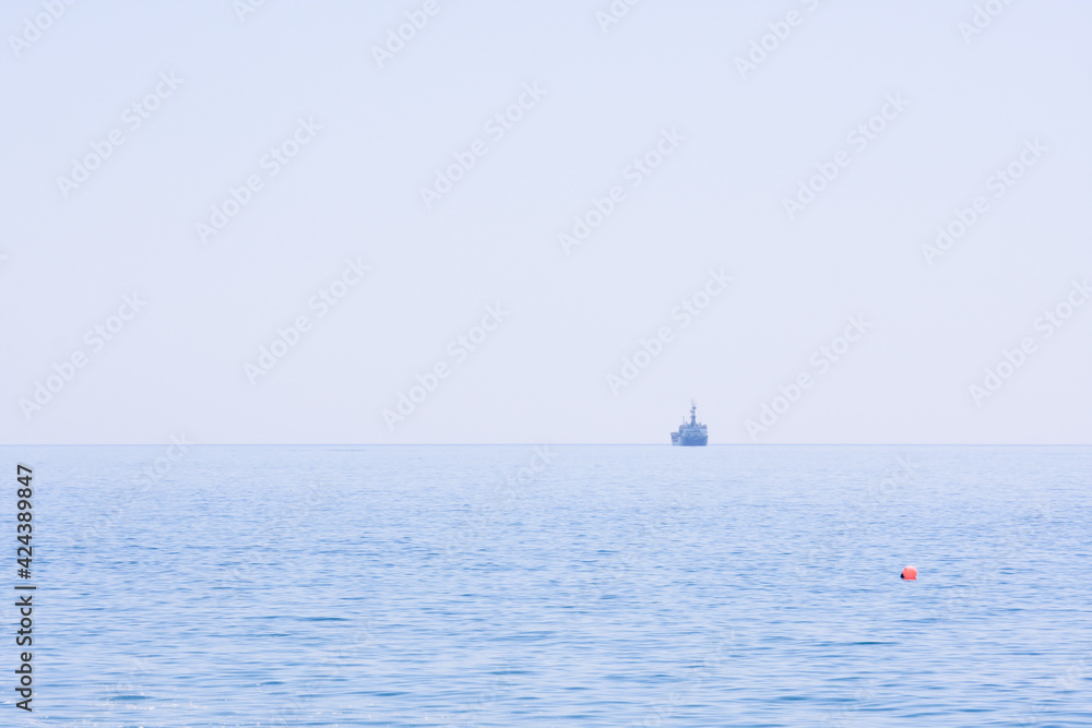 Ships on the seascape horizon, natural blue background, pure sky