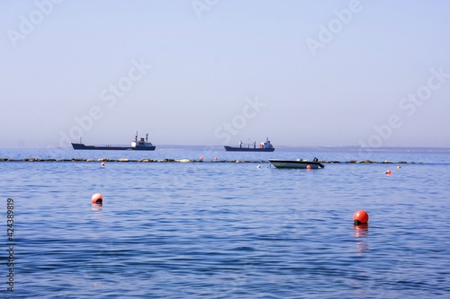 Ships on the seascape horizon, natural blue background, pure sky photo