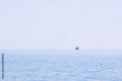 Ships on the seascape horizon, natural blue background, pure sky