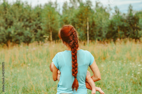 mom hugs her daughter in nature © venerala