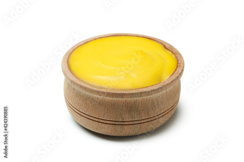 Wooden bowl with mustard isolated on white background