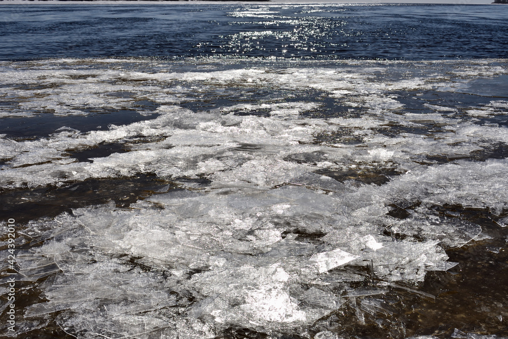 shards of thin ice in the sunlight near the riverbank, early spring concept shards of thin ice in the sunlight near the riverbank, early spring concept