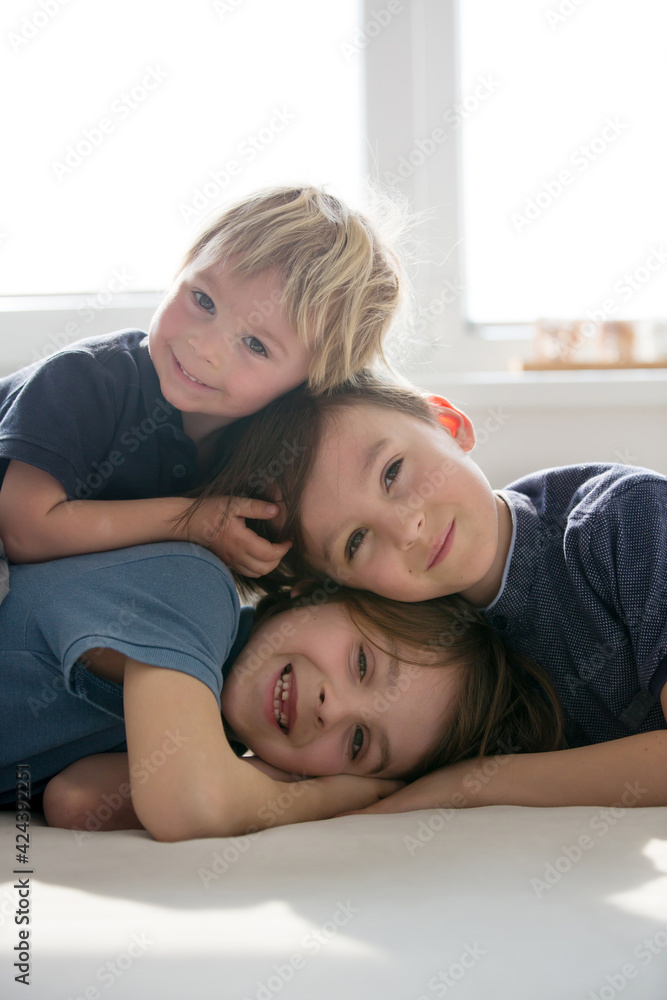 Three beautiful children, boy brothers, having family portrait, hugging Three beautiful children, boy brothers, having family portrait, hugging