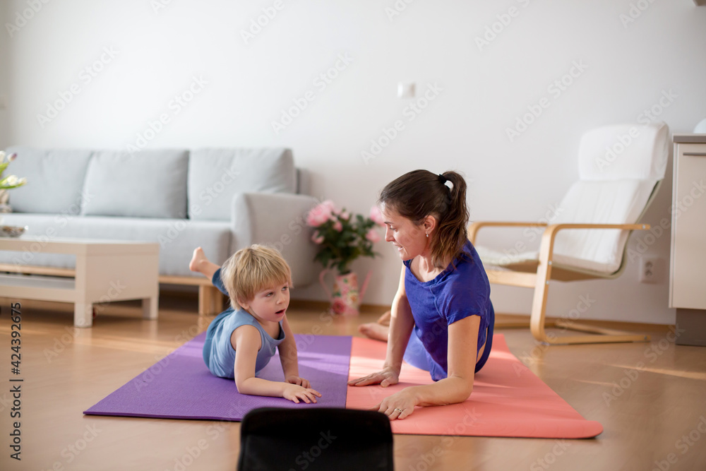 Mother and children, exercising at home during coronavirus, people making gymnastic at home - obrazy, fototapety, plakaty 