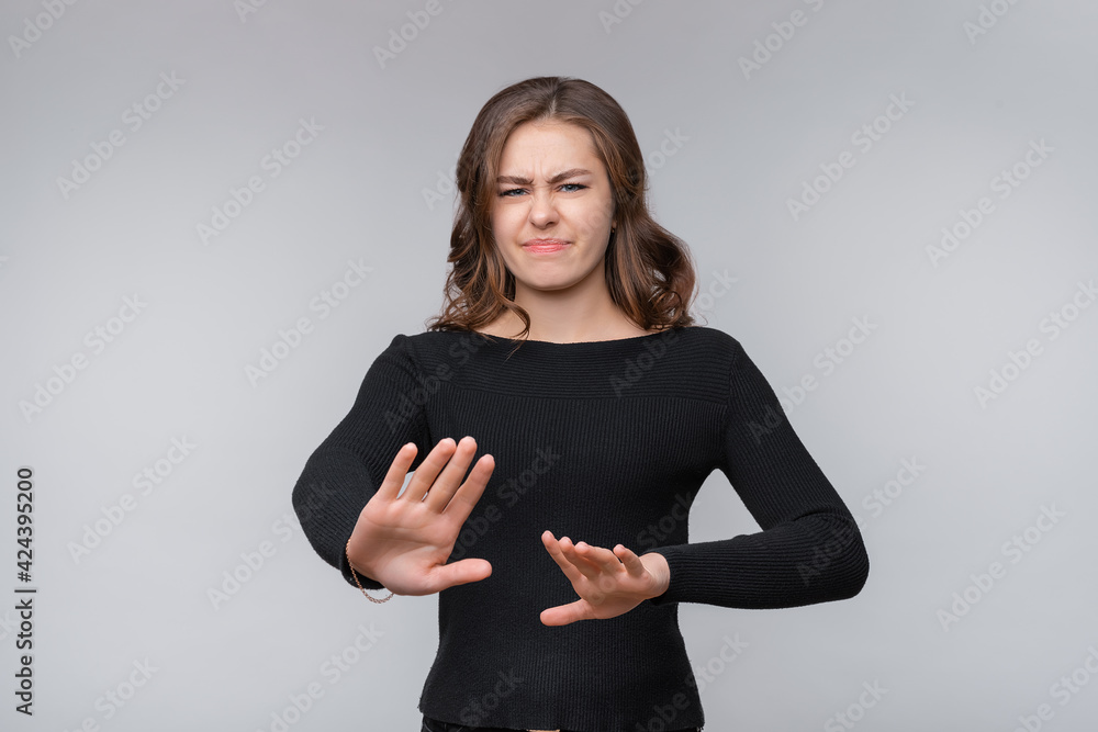 Serious young brunette woman frowning disappointed, rejecting bad offer, express negative opinion and decline Serious young brunette woman frowning disappointed, rejecting bad offer, express negative opinion and decline
