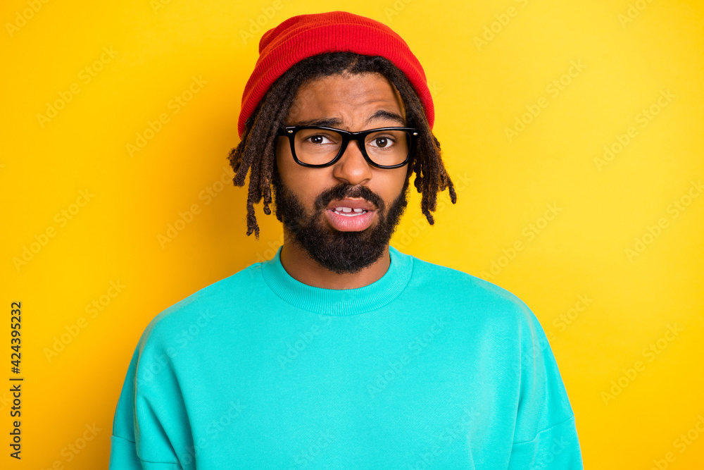 Photo of young african man unhappy sad upset uncertain unsure wear glasses isolated over yellow color background Photo of young african man unhappy sad upset uncertain unsure wear glasses isolated over yellow color background
