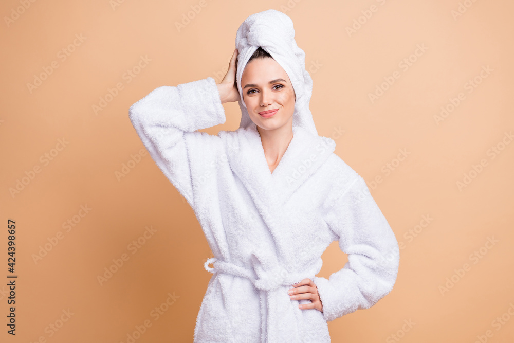 Portrait of charming cheerful girl wearing white bathrobe enjoying relax isolated over beige pastel color background - obrazy, fototapety, plakaty 