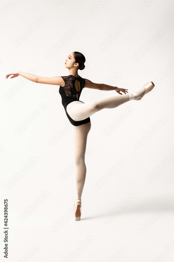 Beautiful japanese ballerina posing on white background