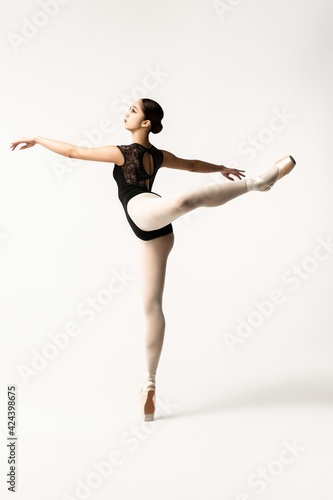 Beautiful japanese ballerina posing on white background