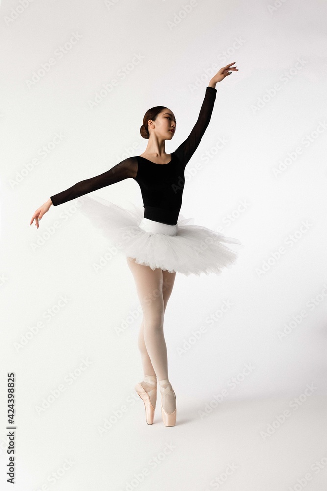 Young ballerina dancing on white background Young ballerina dancing on white background