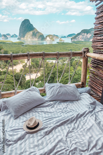hat against Phang Nga bay background, Tourists relaxing in tropical resort at Samet Nang She, near Phuket in Southern Thailand Fototapet