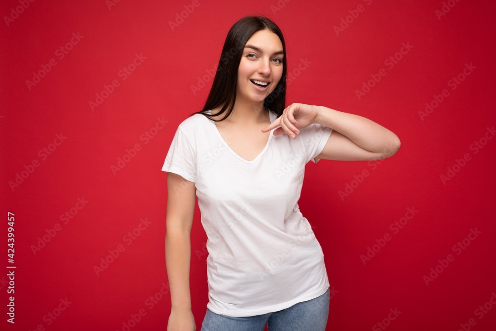 Photo of beautiful positive smiling adult woman wearing stylish clothes standing isolated on colorful background with copy space looking at camera. Mock up Photo of beautiful positive smiling adult woman wearing stylish clothes standing isolated on colorful background with copy space looking at camera. Mock up
