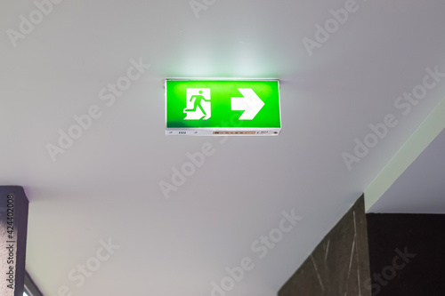 Fire Emergency exit sign on the wall background inside building. Safety concept