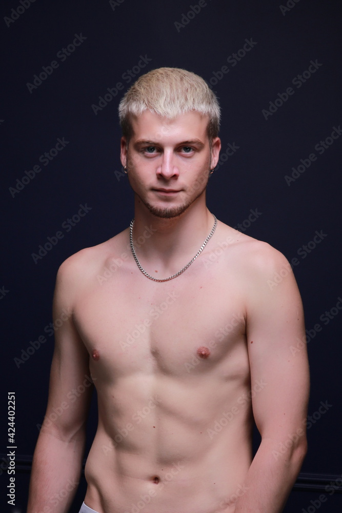 Fototapeta premium A young and masculine guy poses in the torso.