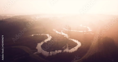 drone video fottage of sunrise over river fogs photo