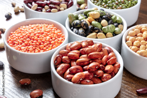 Legumes assortment in bowls on a wooden table