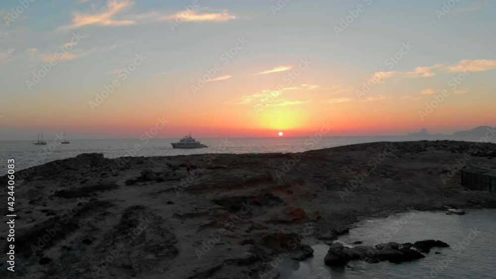 Drone view of the sunset from an island in Formentera, Spain Drone view of the sunset from an island in Formentera, Spain