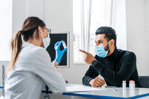 Photography Photo of the doctor and the patient during the consultation before vaccination