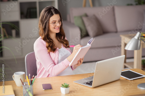 Portrait of attractive focused cheerful pregnant girl staying home writing planner notes safe self isolation house indoors © deagreez