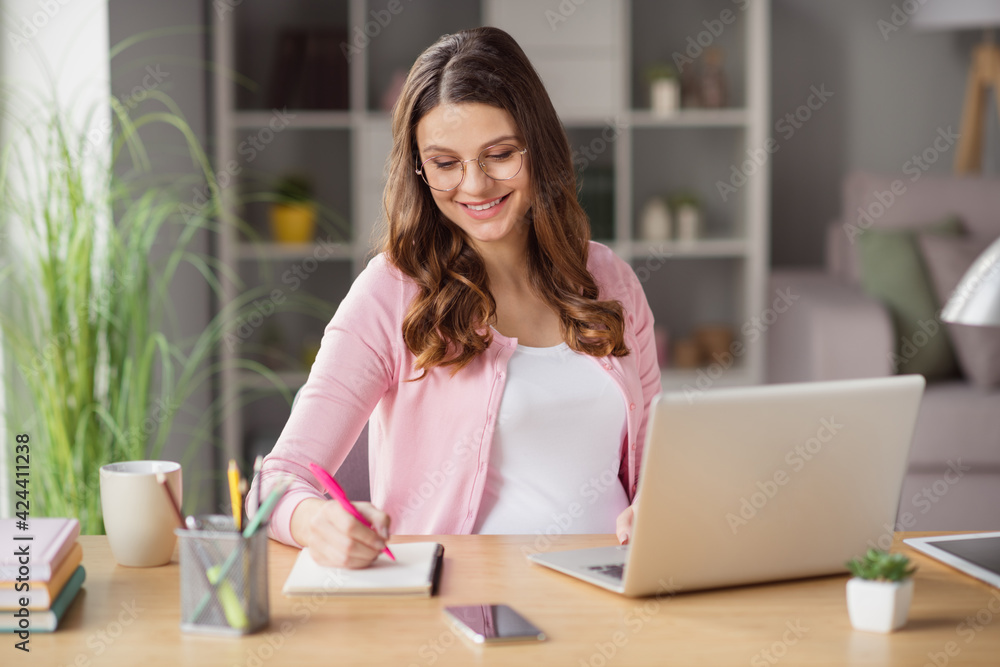 Portrait of pretty focused smart clever cheerful pregnant girl staying home writing esssay working remotely in house indoors Portrait of pretty focused smart clever cheerful pregnant girl staying home writing esssay working remotely in house indoors
