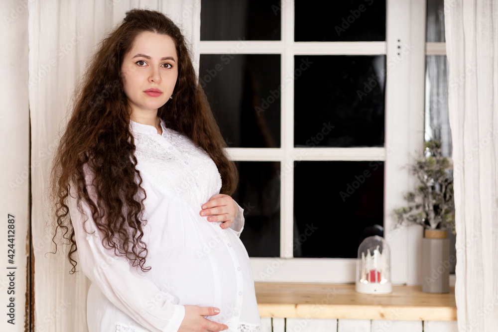 young beautiful sad upset pensive pregnant woman hug her belly, feel bad. anxious caucasian girl with big tummy expecting baby. stressful, stressed motherhood. fear of childbirth