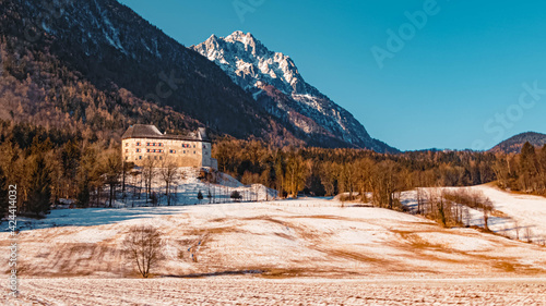 Beautiful winter landscape with fortress Staufeneck and the famous Hochstaufen summit in the background on a sunny morning at Pieding near Bad Reichenhall, Bavaria, Germany photo