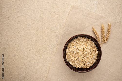oatmeal for breakfast on a linen background with wheat. copy space
