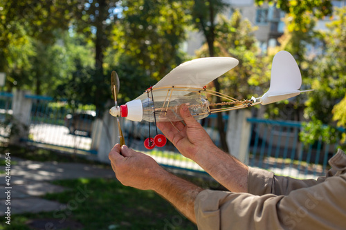 Fotografie Airplane model with a propeller made from household waste plastic on a backgroun