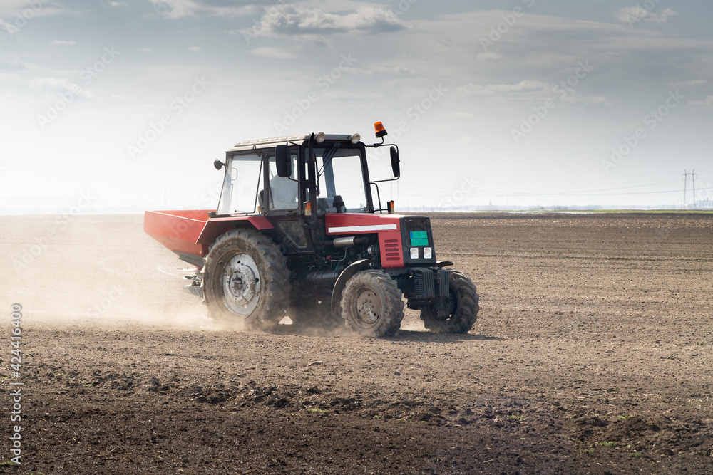 Tractor spreading artificial fertilizers Tractor spreading artificial fertilizers