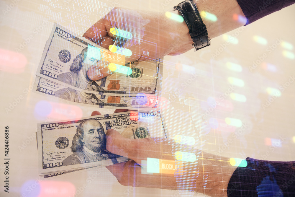 Multi exposure of technology drawing hologram and us dollars bills and man hands. Data concept Multi exposure of technology drawing hologram and us dollars bills and man hands. Data concept