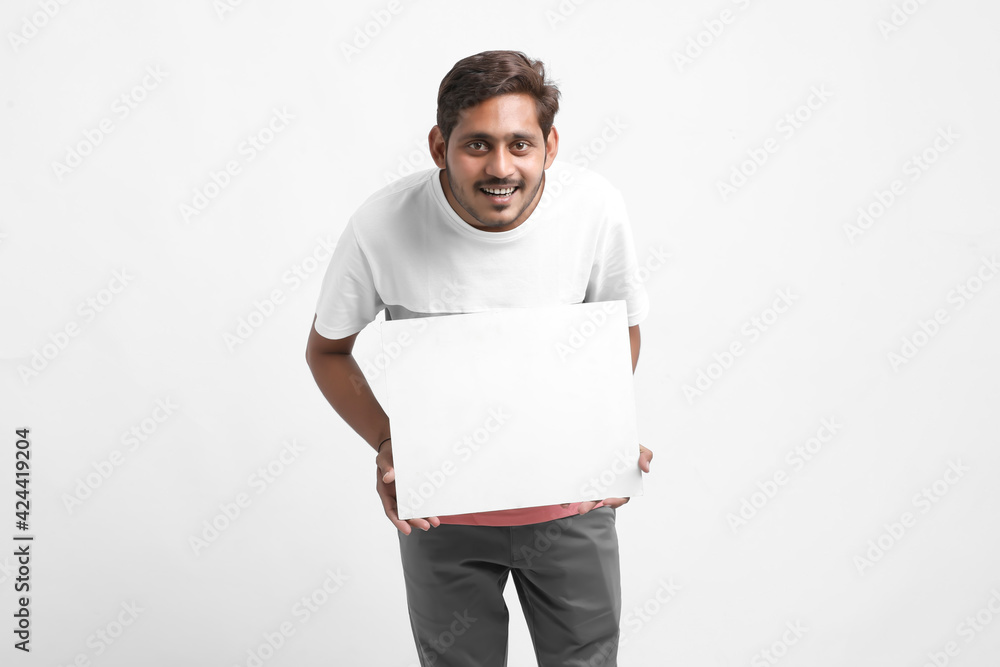 Indian college student showing blank signboard on white background. Indian college student showing blank signboard on white background.