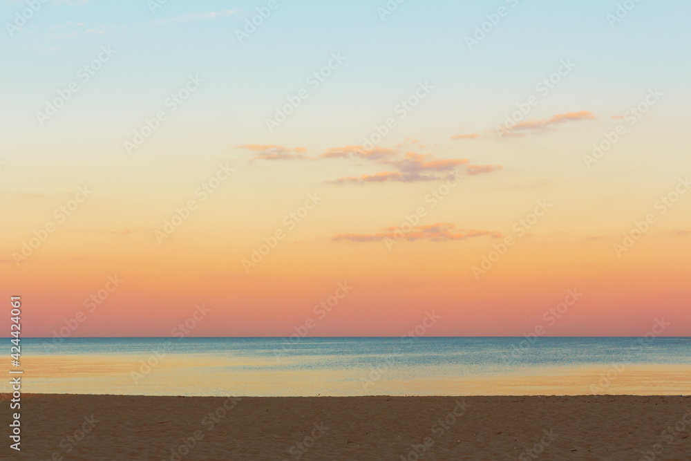Calmness seaside . Calm sea water surface view from the beach  . Dawn over the sea