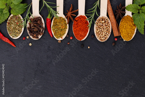 Various spices on dark background. Top view with copy space