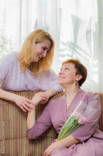 A young girl congratulates her mother on the holiday.