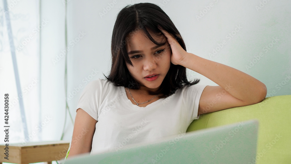 Stressed Asia woman work from home with computer at home