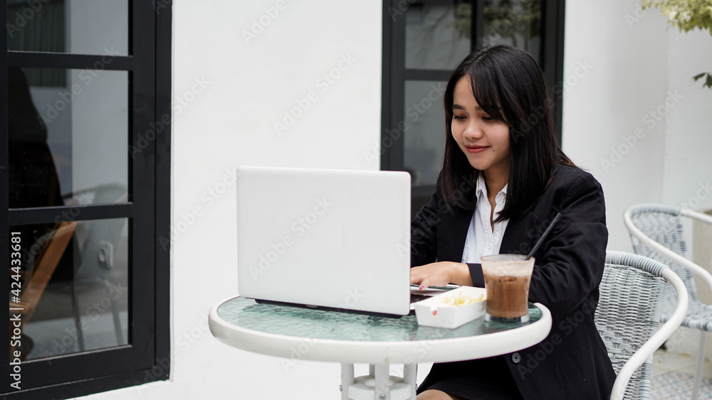 Asian business woman working with his laptop at cafe Asian business woman working with his laptop at cafe