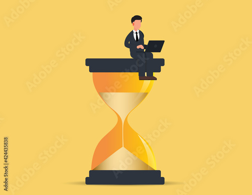 Businessman in sitting on an hourglass and working on laptop.productivity and time management concept.