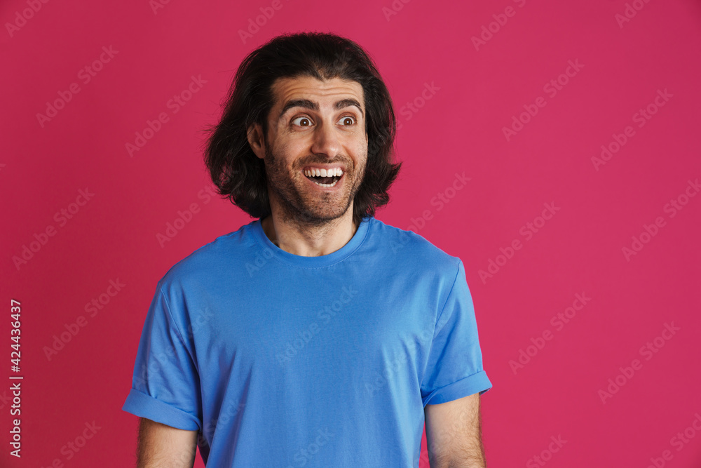 Excited brunette man in t-shirt exclaiming and looking aside Excited brunette man in t-shirt exclaiming and looking aside