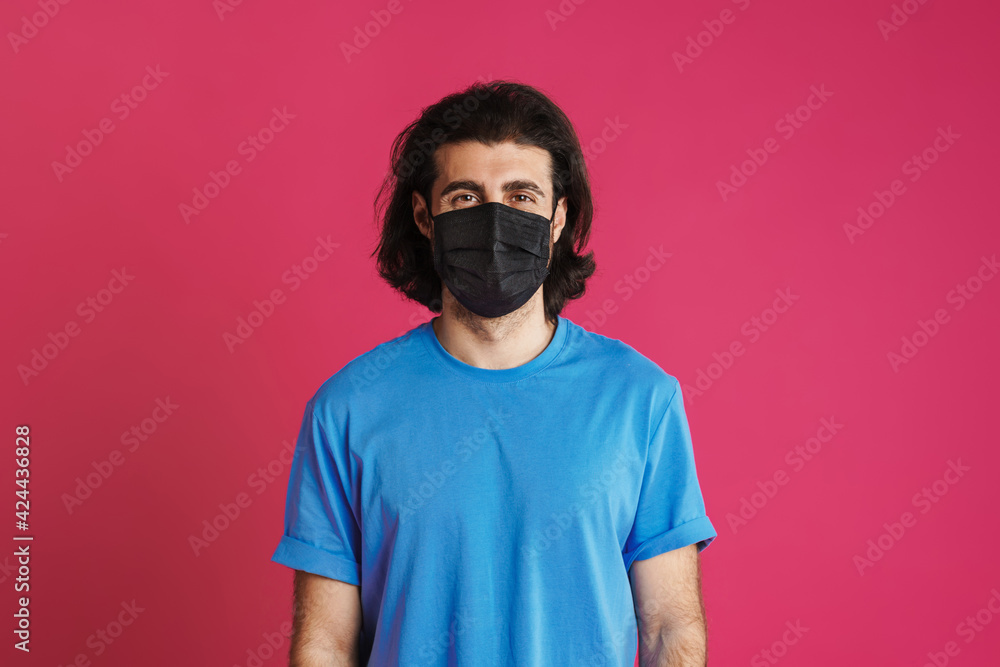 White brunette man in face mask posing and looking at camera White brunette man in face mask posing and looking at camera